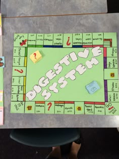 a board game sitting on top of a table with pieces of paper and magnets