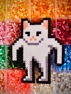 an image of a cat made out of plastic beads on a rainbow colored background with the word hello kitty