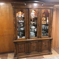 an antique china cabinet with glass doors