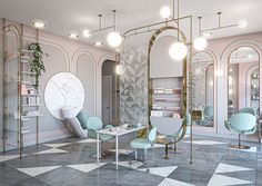 the salon is decorated in pastel colors and features round mirrors, circular stools, chairs, and shelves