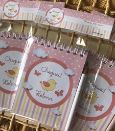 several personalized notepads are on display in a wicker basket for sale