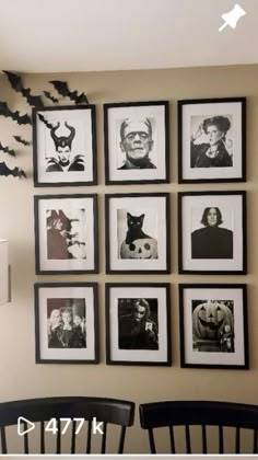 black and white halloween pictures hung on the wall above two chairs in front of them