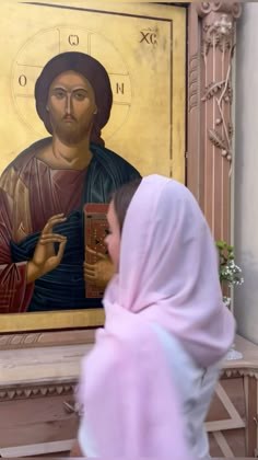 a woman standing in front of a painting