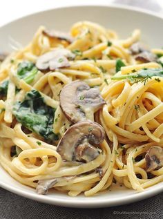 a white bowl filled with pasta and mushrooms