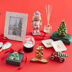 christmas decorations and ornaments are arranged on a red surface with a white frame in the middle