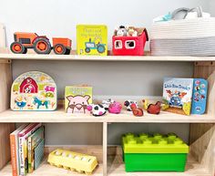 children's books and toys on shelves in a playroom or nursery room,