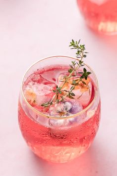 pink lemonade cocktail in a glass with ice and garnish