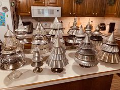 a kitchen counter topped with lots of metal pots and pans