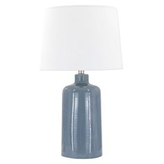 a blue table lamp with a white shade on the base and a light bulb attached to it