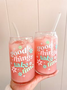 two glasses with straws in them that say good things take time