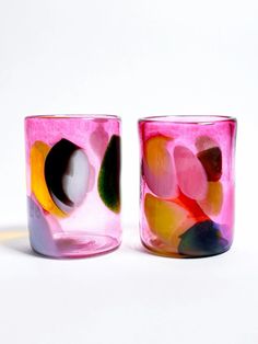 two colorful glass cups sitting next to each other