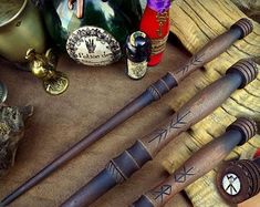 several different types of baseball bats are on the ground next to bottles and other items