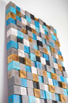 a painting made out of wood blocks with blue and brown squares on it's sides