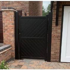 a brick house with a white door and black gate