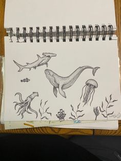 a notepad with drawings of sea animals on it