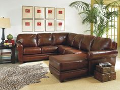 a brown leather sectional sofa and ottoman in a living room