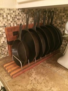 a rack with pots and pans hanging from it