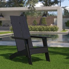 a lawn chair sitting on top of a lush green field next to a swimming pool