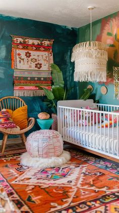 a baby's room decorated with colorful rugs and wall hangings, including a crib