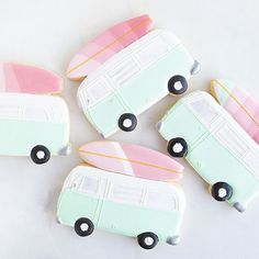 decorated cookies in the shape of surfboards and buses