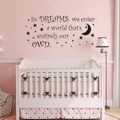 a baby's room with a crib and wall decal that says, in dreams we enter a world that is entirely our own