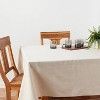 a wooden chair sitting next to a white table