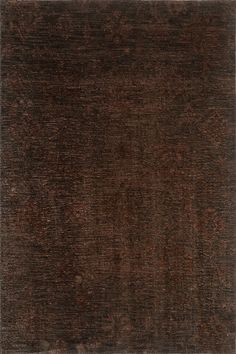 an area rug with dark brown colors