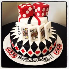 a birthday cake decorated with dice and playing cards