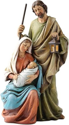 a statue of jesus holding a baby in his arms and an old fashioned candle on the side