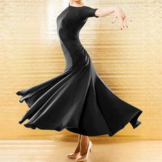 a woman in a black dress is dancing