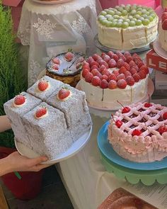 a table topped with cakes and desserts covered in frosting on top of plates