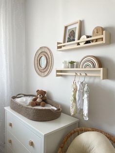 a baby's room with a teddy bear in the crib and shelves above it