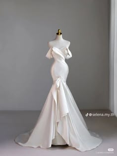 a white wedding dress on a mannequin