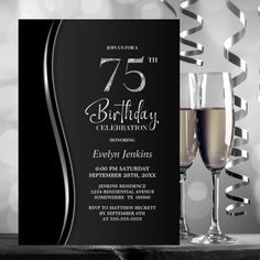 a black and white birthday party card with two glasses of wine on the table next to it