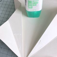 a bottle of liquid sitting on top of some paper