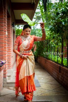 a woman in an orange and white sari