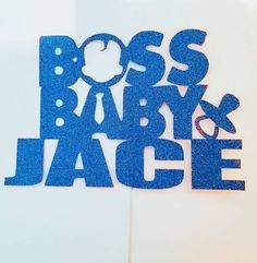 a blue cake topper that says boss baby and jacquet on it's side