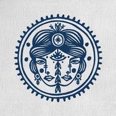 a blue and white drawing of a woman's face in a circle with trees on it