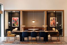 a dining room table with four chairs around it and an area rug on the floor