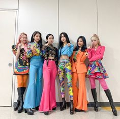 the girls are posing together in colorful outfits