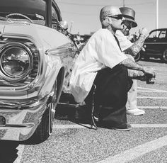 a man sitting on the hood of a car