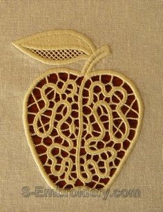 an embroidered apple with a leaf on it