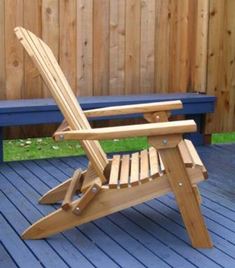 a wooden chair sitting on top of a blue deck