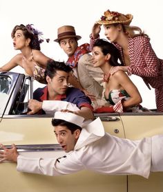 a group of people that are standing in the back of a car with hats on