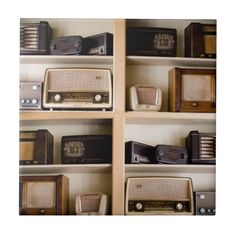 many old radio's are on shelves in a room