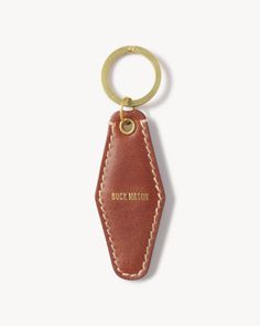 a leather keychain with the words buck mason on it