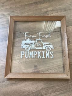 a wooden frame with a drawing of a truck and the words farm fresh pumpkins