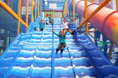 two people on a slide in an indoor water park