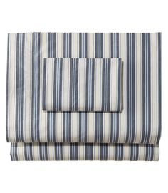 the blue and white striped sheet set is folded on top of each other, with two pillows