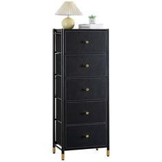 a tall black cabinet with five drawers and a white lamp on top of it in front of a white background